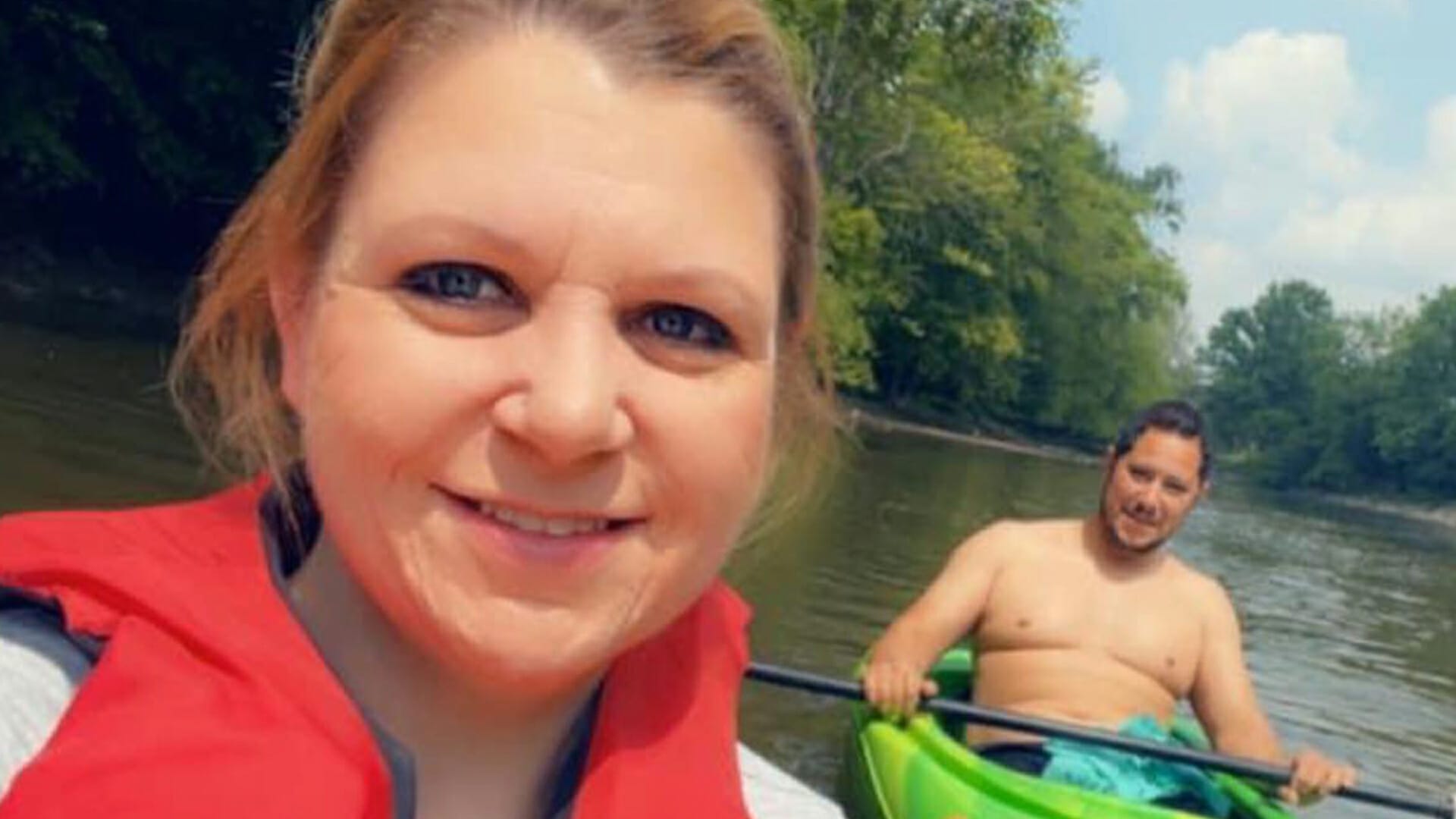 A couple taking a selfie while kayaking with Atwater Paddles equipment on the Huroc Park river.