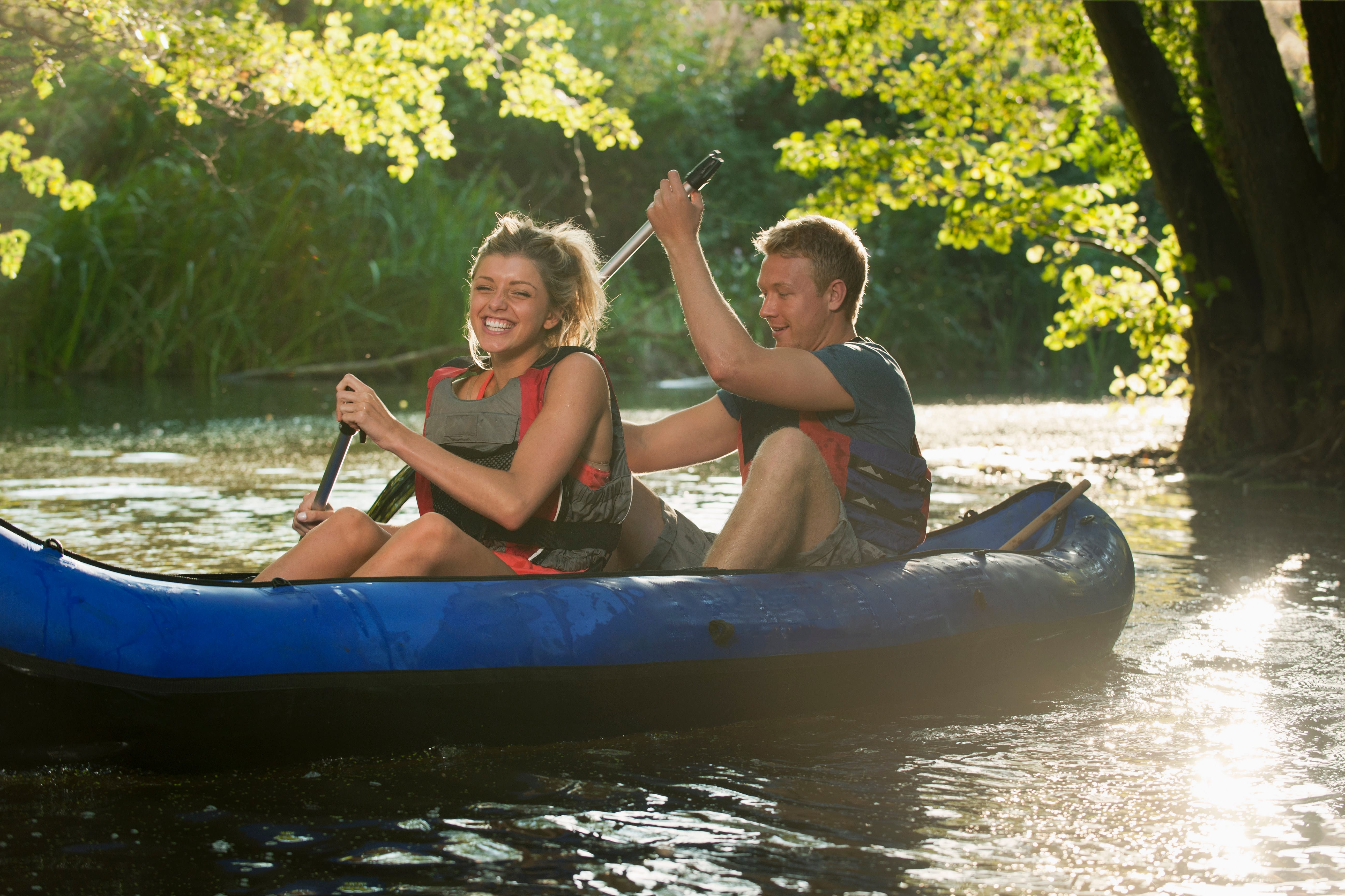 Couple kayaking together on the Huron River near Detroit for a romantic date.